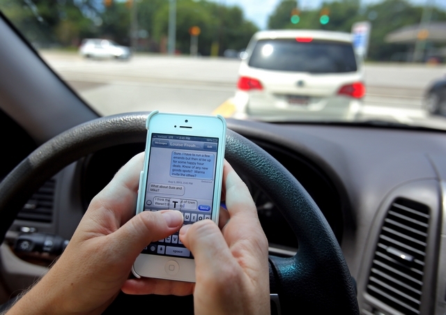 A driver texting in traffic